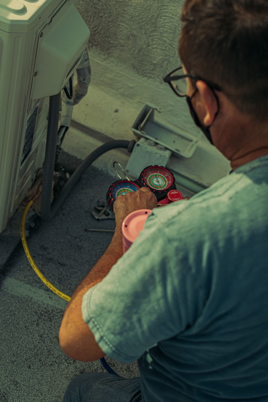 HVAC technician servicing an air conditioning system for Caroline County HVAC
